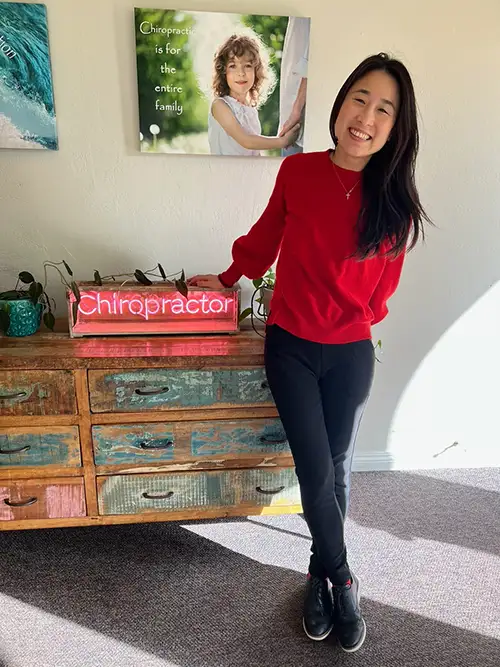 Kerry (Chia-Hua) Chan With Chiropractor Sign